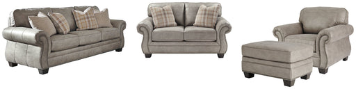 Olsberg set featuring sofa, loveseat, chair, and ottoman in steel gray upholstery with elegant nailhead trim and accents.