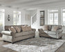 Olsberg sofa and loveseat in a stylish living room, featuring steel gray upholstery, plaid pillows, and nailhead trim.